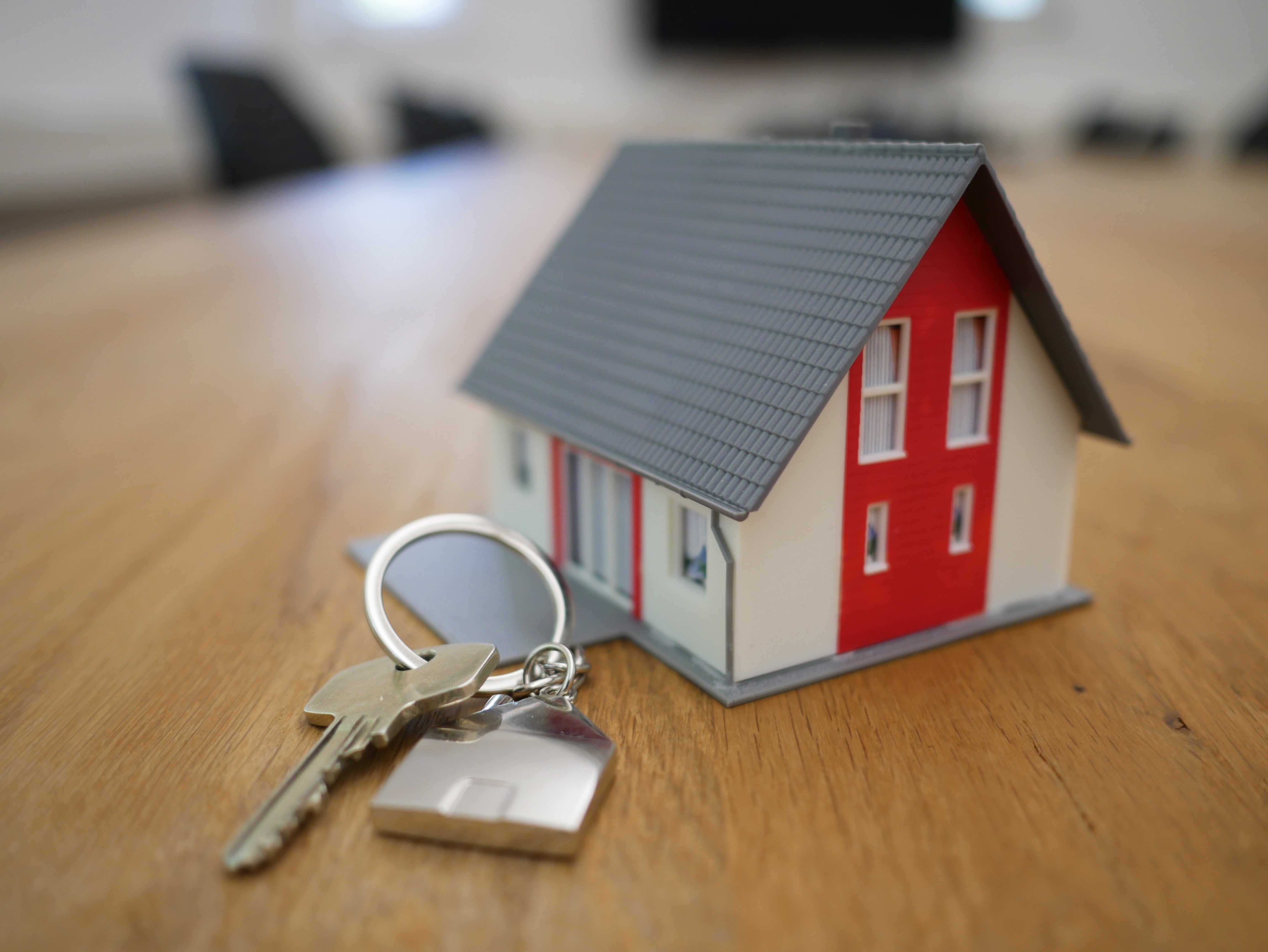 A house model with keys on a table. Learn how to make an offer and make this home yours. A comprehensive guide to the home-buying process.